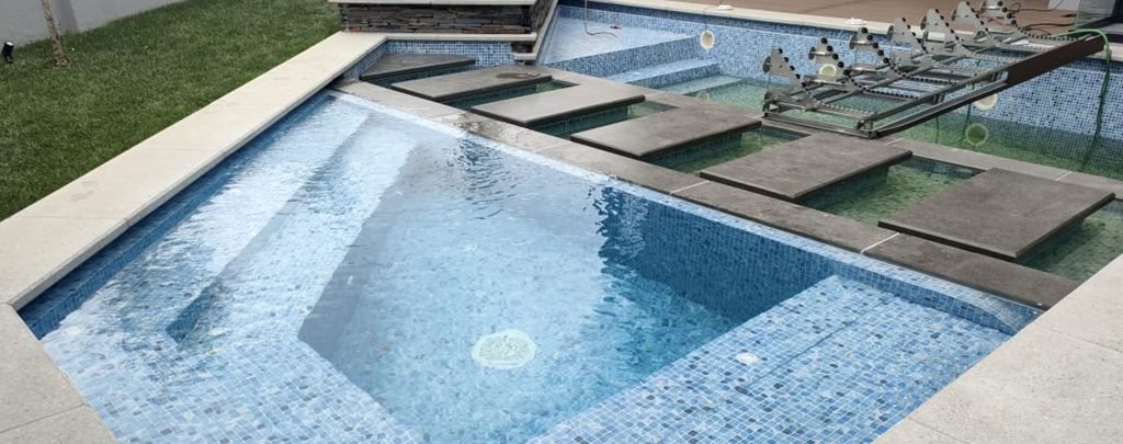 designer pool covers A backyard swimming pool with steps and pool covers.