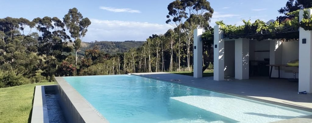 designer pool covers A hillside swimming pool with pool covers.