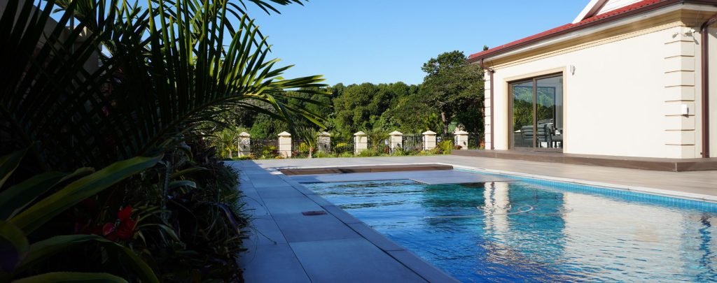 designer pool covers A house with a swimming pool.