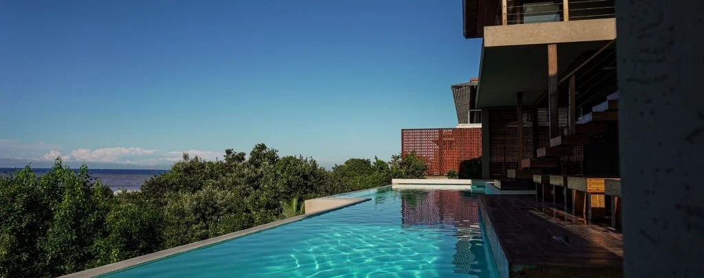 designer pool covers A pool with a view of the ocean.