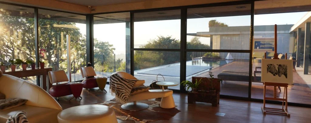 designer pool covers A spacious living room with floor-to-ceiling windows.