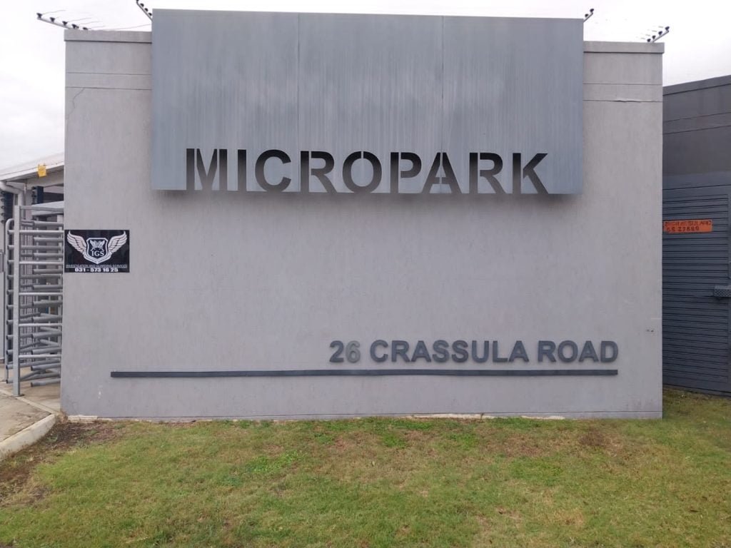 designer pool covers A sign that says micropark in front of a building.