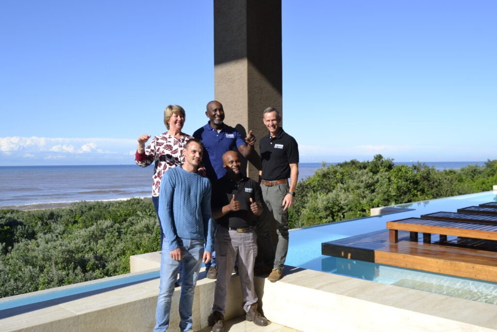 designer pool covers Designer pool covers durban showcased with a group of people standing next to a pool.