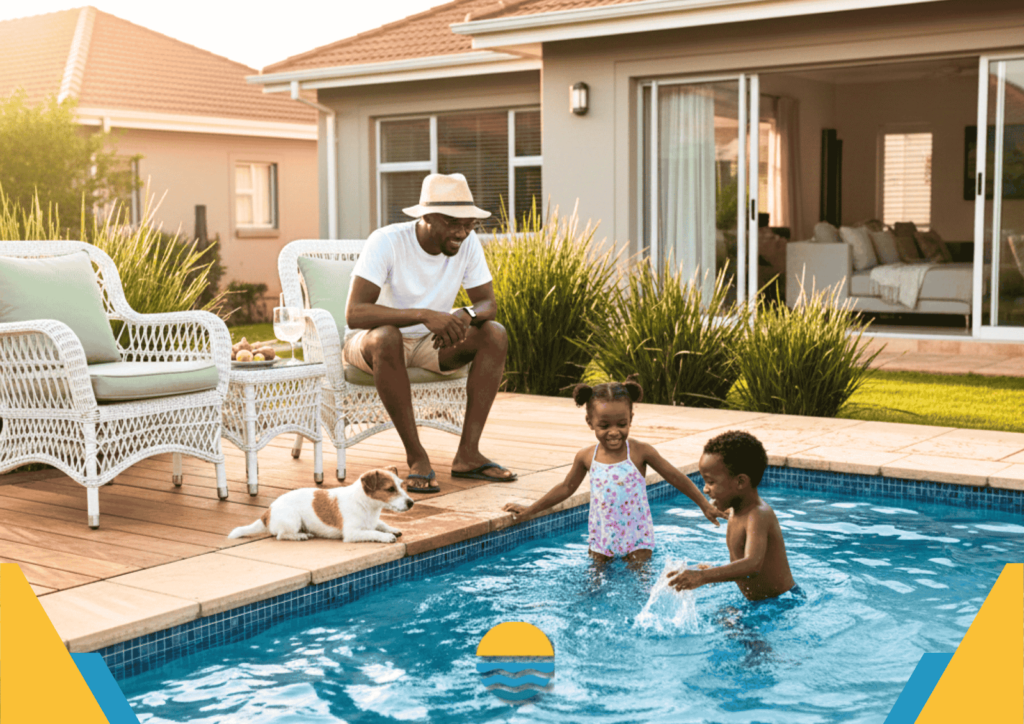 A man sits by a backyard pool watching two children play in the water while a small dog rests nearby. Residential home and patio furniture are visible in the background.